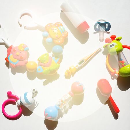 Colorful baby rattles on a white background Contrasting shadows top view flat layの写真素材