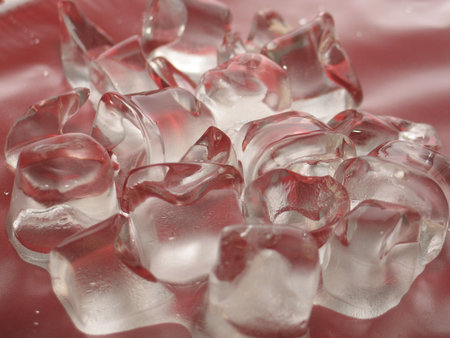 Ice cubes on red background