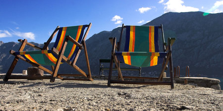 Two beach chairs on stone pierの写真素材