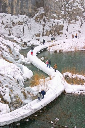 Plitvice - winter landscape with lake, path and some touristsの写真素材