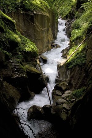 Little waterfall - water well - hidden in forest shadows, Austrian Alpsの写真素材