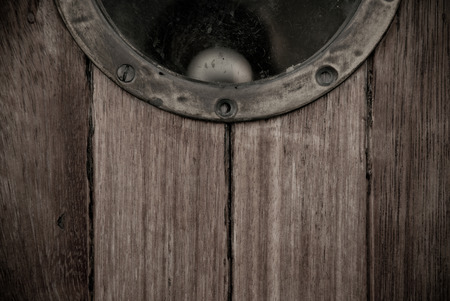 Close-up of a wooden boat closed porthole の写真素材