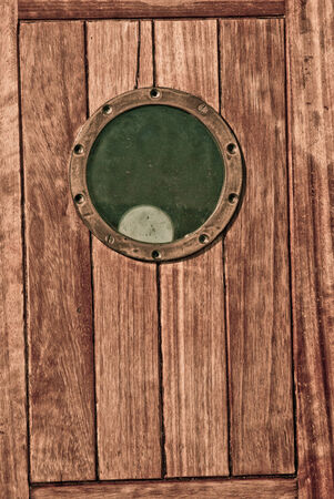 Close-up of a wooden boat closed porthole の写真素材