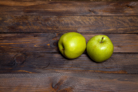 Two fresh green apples on wooden backgroundの写真素材