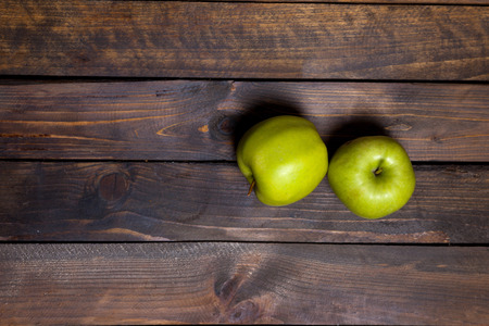 Two fresh green apples on wooden backgroundの写真素材