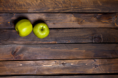Two fresh green apples on wooden backgroundの写真素材