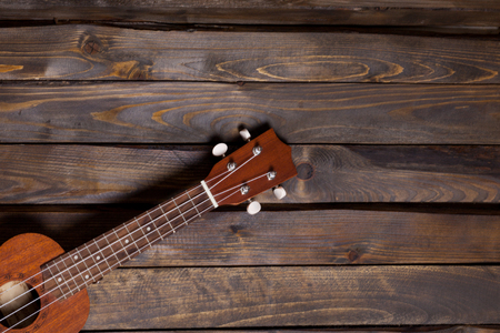 Musical string instrument ukulele on wooden backgroundの写真素材