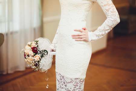 Beautiful bride in white wedding dress holding bouquet.の写真素材