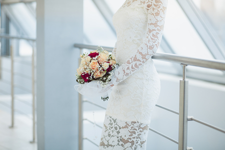 Beautiful bride in white wedding dress holding bouquet.の写真素材