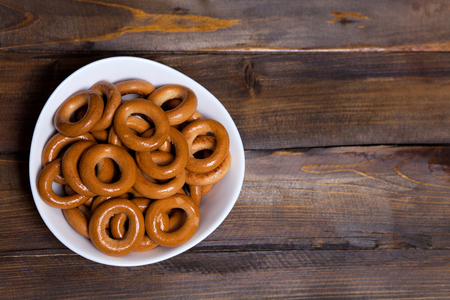 Russian bagels, bread in a white plate on wooden background.の写真素材