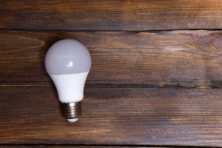 White LED light bulb on wooden background.の写真素材