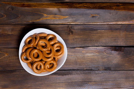 Russian bagels, bread in a white plate on wooden background.の写真素材