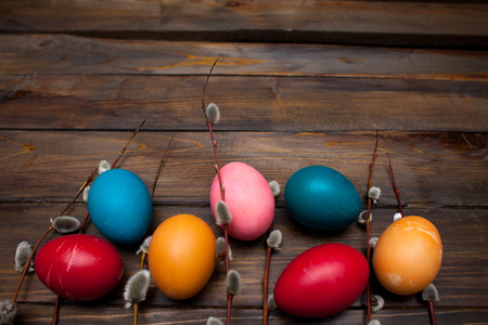 Beautiful branch of willow and easter eggs wood background.の写真素材