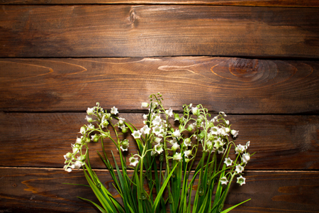 Beautiful spring flowers lily of the valley on woodward wooden background.の写真素材