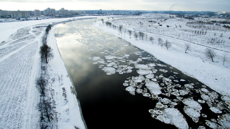 Ice swims in the river. Winter landscape photographed from above near the city. Top view. Nature and abstract background.の写真素材