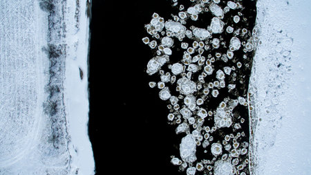 Ice swims in the river. Winter landscape photographed from above. Top view. Nature and abstract...