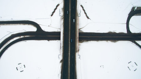 Winter road in the city from a height. Photo taken by quadrocopter. Asphalt road with cars.