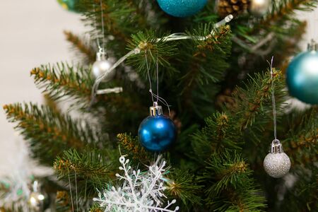 Beautiful green Christmas tree decorated with balls and garlands. Close-up photoの写真素材