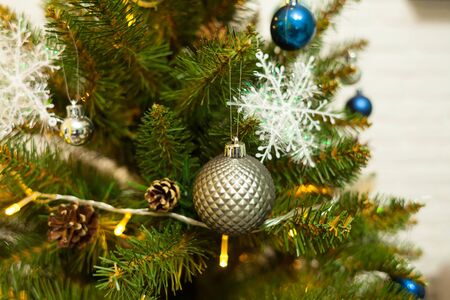 Beautiful green Christmas tree decorated with balls and garlands. Close-up photoの写真素材
