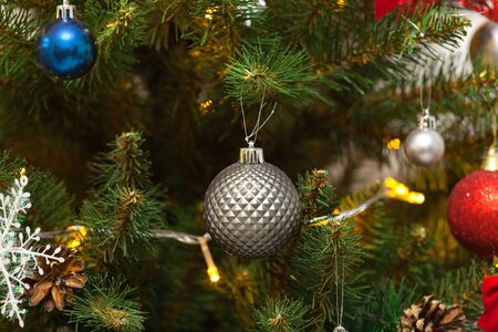 Beautiful green Christmas tree decorated with balls and garlands. Close-up photoの写真素材