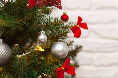 Beautiful green Christmas tree decorated with balls and garlands. Close-up photoの写真素材