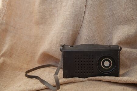 old soviet tape recorder on a flax texture backgroundの写真素材