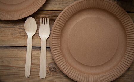 eco paper plate dish fork on old wooden tableの写真素材