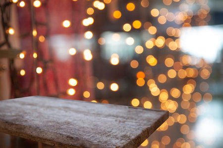 wooden table on blurred lightbulb cafe background