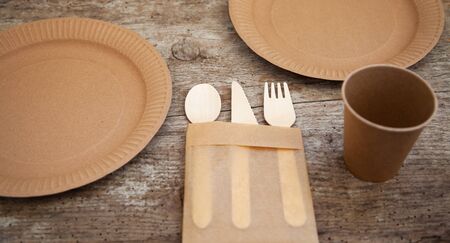 ecological disposable tableware paper cardboard empty on a wooden tableの写真素材