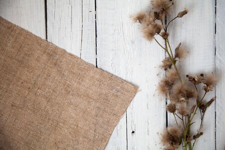empty wooden white background with napkin and flowerの写真素材