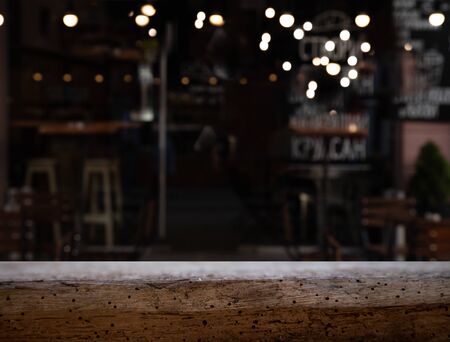 vintage wooden table on blurred cafe background dining room restaurantの写真素材
