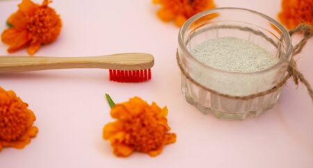 Wooden brushes and tooth powder on a pink background. Zero waste concept, close up.の写真素材