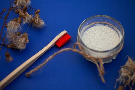 Wooden brushes and tooth powder on a blue background.の写真素材