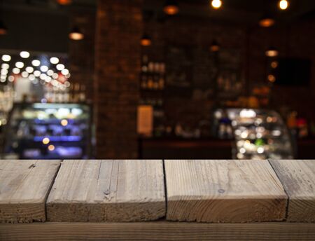 vintage wooden table on blurred cafe background dining room restaurantの写真素材