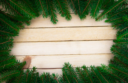 Christmas toys with fir branches on a wooden table, gift box, empty place, New Year concept. View...