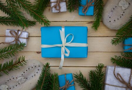 Christmas toys with fir branches on a wooden table, gift box, empty place, New Year concept. View from above.の写真素材