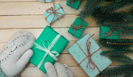 Christmas toys with fir branches on a wooden table, gift box, empty place, New Year concept. View from above.の写真素材