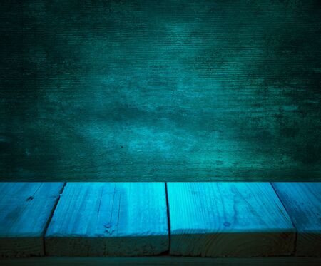 Dark wooden background. with an empty table. place for text.の写真素材