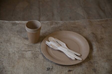 Eco paper utensils with cardboard, paper, wood. On an old wooden table, concept of zero plastic.の写真素材