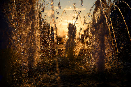 Water blurred splash in sunset light backgroundの写真素材