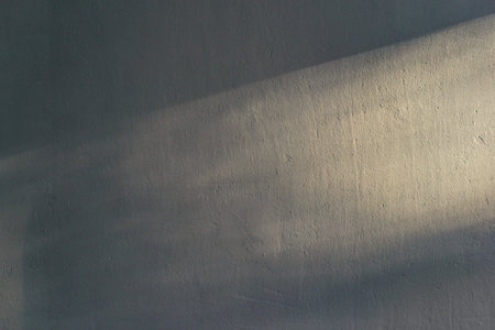 Ray of light on textured wall background