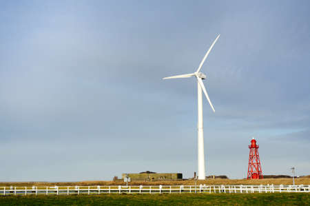 Wind turbine and lighthouse background with free spaceの写真素材