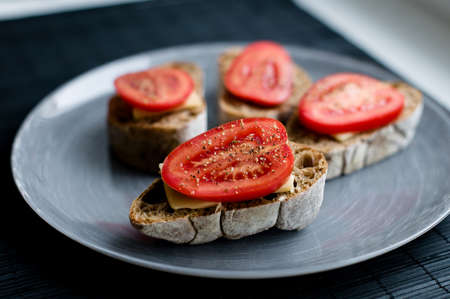 Plate of homemade bruschetta with tomato on a tableの写真素材