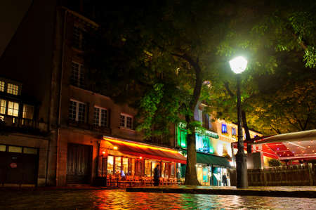PARIS, FRANCE - 12th of OCTOBER 2012: Cafe on square in Montmartre by night. October 12th, 2012. Paris, France.のeditorial素材