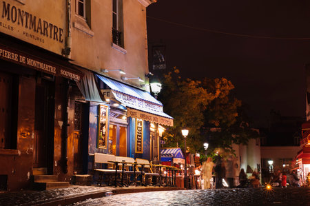 PARIS, FRANCE - 12th of OCTOBER 2012: Cafe on square in Montmartre by night. October 12th, 2012....