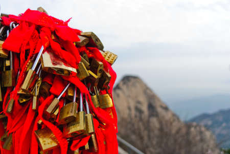 Locks with red bows on mountain Huashan in Chinaの写真素材