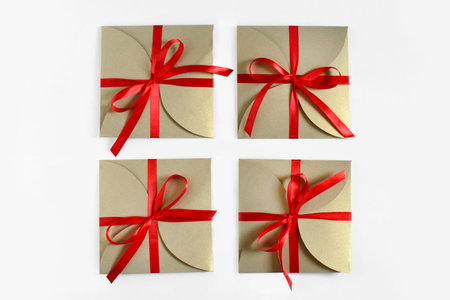 Christmas gifts wrapped in brown paper with the bow top view isolated on white background
