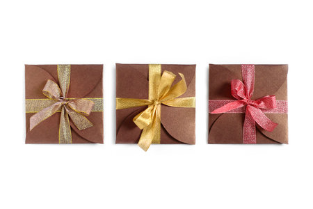 Christmas gifts wrapped in brown paper with the bow top view isolated on white background