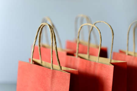 Red shopping bags from recycle paper isolated on white background. Black friday or Christmas sales.の写真素材