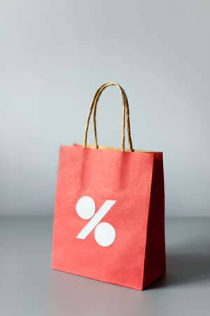 Red shopping bag from recycle paper isolated on white background. Black friday or Christmas sales.の写真素材